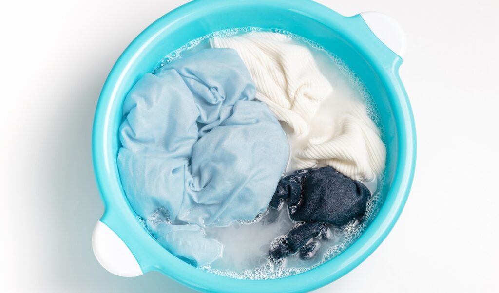 Blue basin with clothes soaking inside