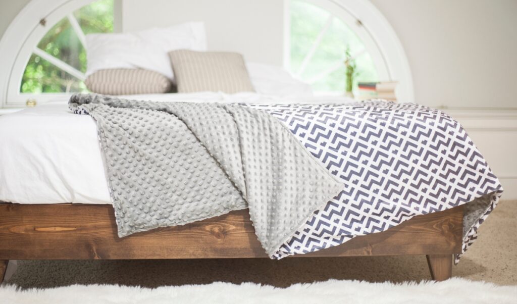 How to wash a weighted blanket: weighted blanket lying on the side of a bed