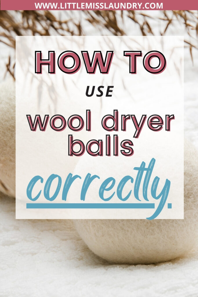 The image features a Pinterest pin with the headline "How to Use Wool Dryer Balls Correctly" in bold, stylized fonts. The background includes a close-up of white wool dryer balls resting on a soft white fabric, with a sprig of dried grass visible in the upper part of the image.