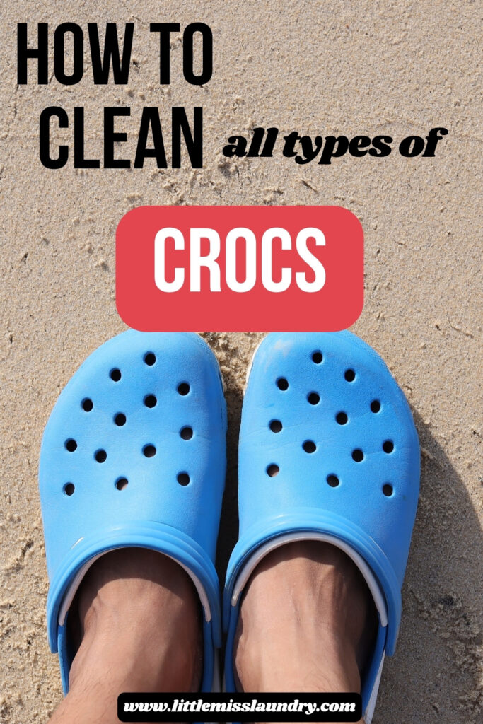 Person wearing bright blue Crocs standing on a sandy beach with text that says "How to clean all types of Crocs" above the shoes. The website "littlemisslaundry.com" is shown at the bottom.